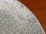 a plate with a cracky design on it on a wooden table
