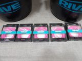 three black mugs with pink and blue logos on them sitting on a table