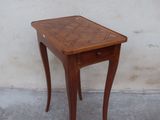 a small wooden table with a drawer on top of it