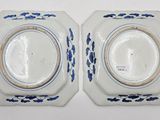 pair of blue and white plates with floral designs on them