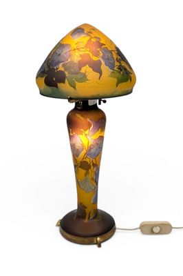 a lamp that is sitting on a table next to a computer mouse