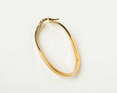a close up of a gold bracelet on a white surface