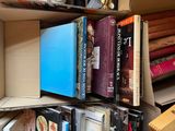 many books that are in a box on the shelf
