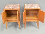 pair of bedside tables with marble tops and open doors