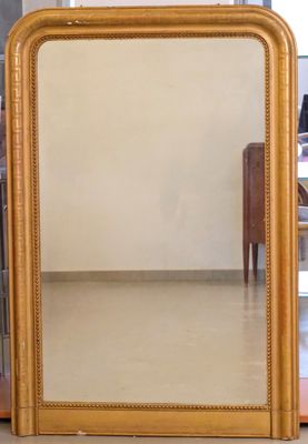 a mirror that is sitting on the floor in front of a table
