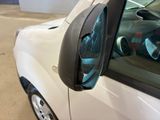 a close up of a car ' s side mirror with a car in the background