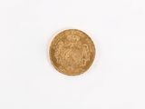 a close up of a gold coin on a white surface