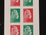 the stamp shows a woman ' s head and four different colors