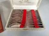 a lot of spoons in a box on a table