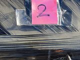 a pink post it note on a pile of black plastic