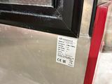 a close up of a metal door with a red handle
