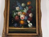 a picture of a painting of flowers and fruit on the wall