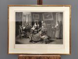 une vieille photo d'un groupe de personnes assises autour d'une table