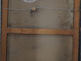 a broken window in the wall of a building that is under construction