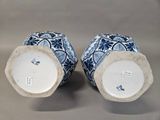 pair of blue and white vases with floral designs on them