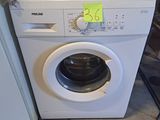 une machine à laver et un sèche-linge placés l'un à côté de l'autre dans une pièce