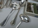 a lot of silver spoons and spoon spoons on a table