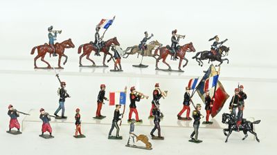 many figurines of soldiers on a white surface