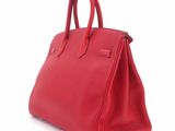 a red leather handbag on a white background