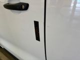 a close up of a door handle on a white car