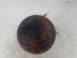 a small wooden ball on the floor in the snow