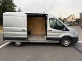 a silver van with its doors open in a parking lot