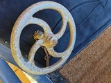 a rusted wheel on the back of a blue car
