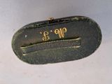 a small black purse with a gold monogram on it