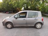 a small silver car parked in a parking lot