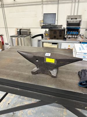 a table with an anvil on it in a workshop