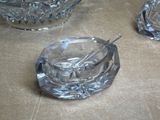 a glass ashtray and a glass ashtray on a table