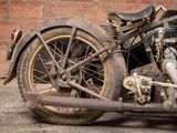 a old motorcycle parked in front of a brick wall