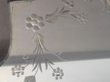 a silver plate with a design on it on a table