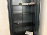 a black metal cabinet with a book shelf in the corner