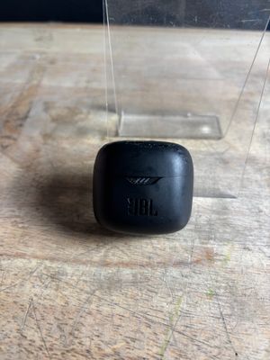 a small black object sitting on a wooden table