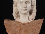 marble bust of a young girl with a frillying collar