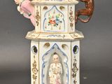 a figurine of a woman and a monkey in a tower
