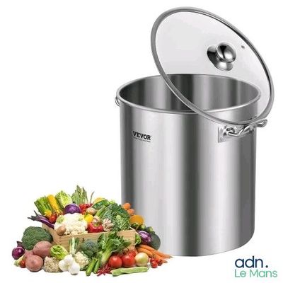 a large pot with a lid next to a pile of vegetables