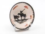 a black and white plate with a picture of a man on a horse