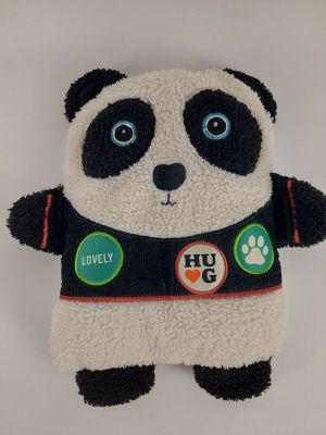 stuffed panda bear wearing a black and white jacket with lots of buttons on it
