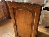 a small wooden cabinet in the middle of a room