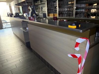a red and white ribbon on the counter of a bar