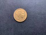 an image of a gold coin on a blue surface