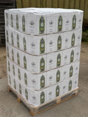 boxes of beer stacked on a pallet in front of a building
