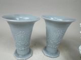 two vases sitting next to each other on a table