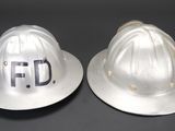 pair of white hard hats with the word f d on them