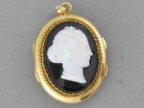 an image of a black and white cameo pendant with a woman ' s head