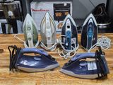 four irons sitting on a table next to each other