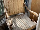 a chair that is sitting in a room by a window
