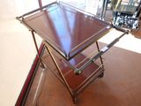 a metal cart with two trays on top of it